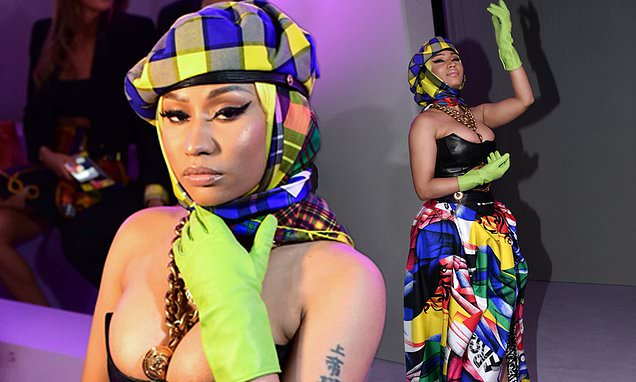Nicki Minaj puts on a VERY busty display in plunging leather corset and bizarre green gloves as she wows on the FROW at Versace MFW show