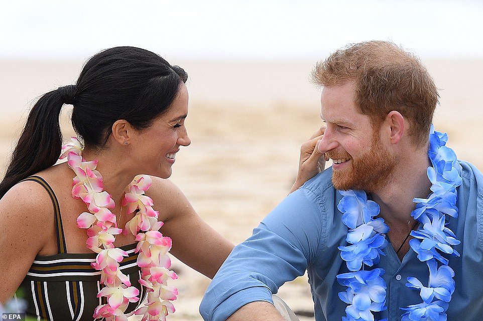 Meghan cradles her baby bump on Sydney beach and wears £880 maxi dress before she and Harry kick off their shoes to join an 'anti-bad vibes circle' with surfing mental health group