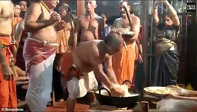 Hindu devotees dip hands in BOILING OIL as a 'test of faith'