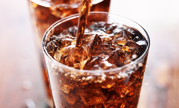 soft drink being poured into glass