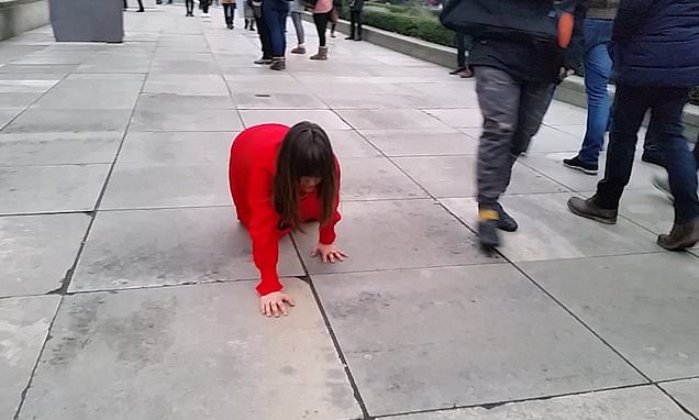 Mystery lady in red spotted crawling outside parliament