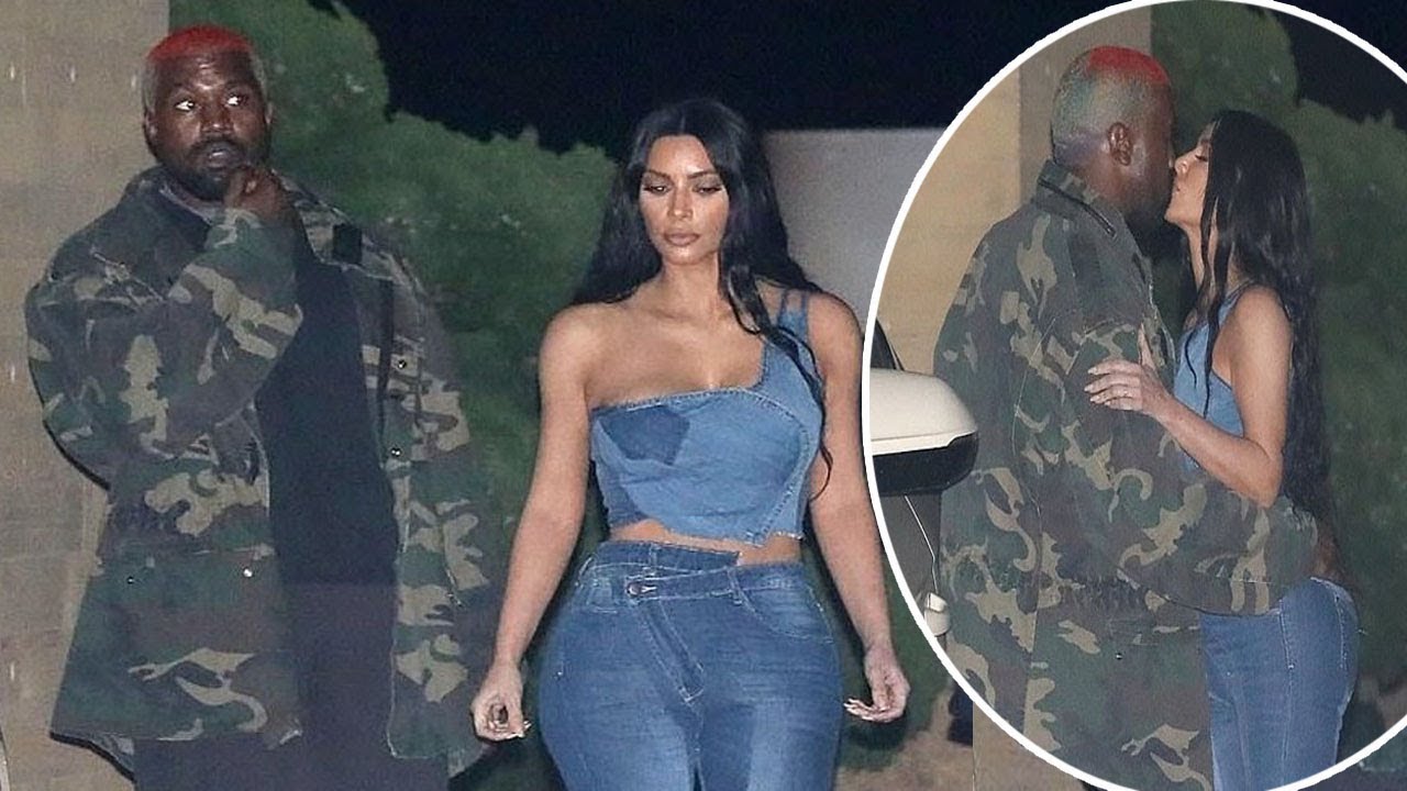 Kim Kardashian flaunts her incredible curves in skintight denim bottoms with a low-cut jean crop top as she shares a kiss with Kanye West at Nobu in Malibu