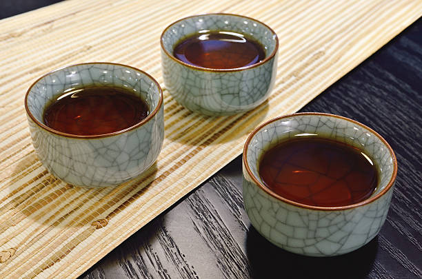 Three cups of black tea in China porcelain.