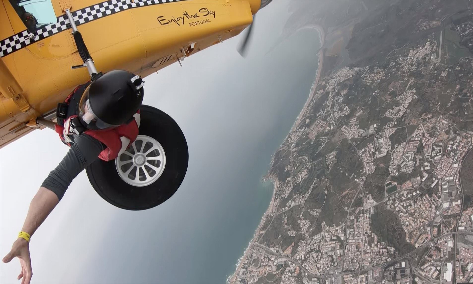 Bananas! Bizarre moment a daredevil climbs out of a plane to take fruit from a wingsuit flier