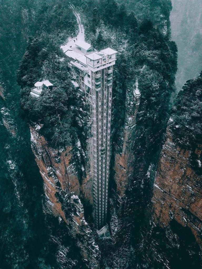 Striking aerial pictures show China's 1,070-foot-tall glass elevator built on the side of a cliff