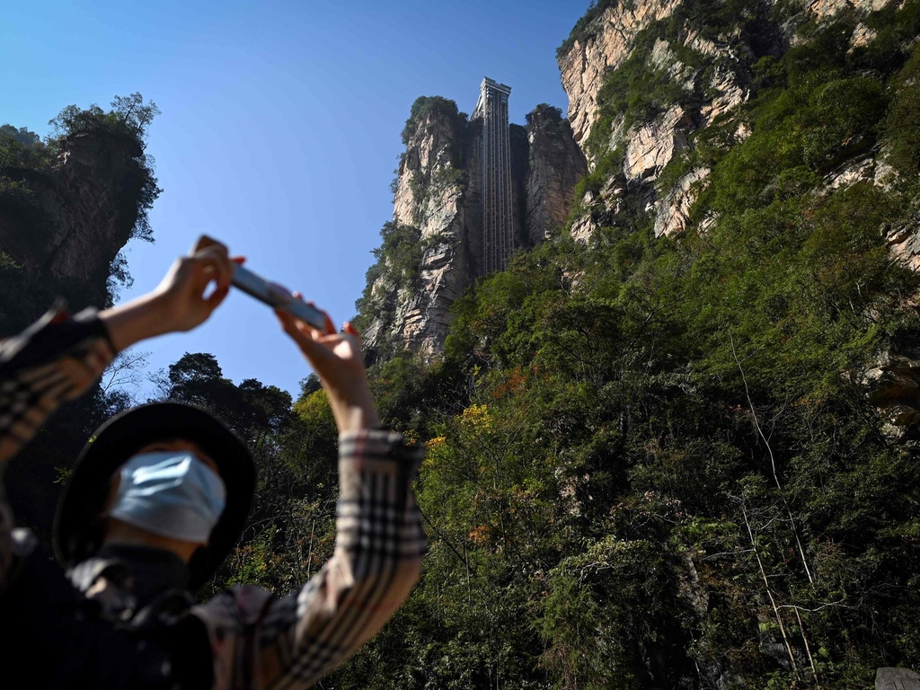 Striking aerial pictures show China's 1,070-foot-tall glass elevator built on the side of a cliff